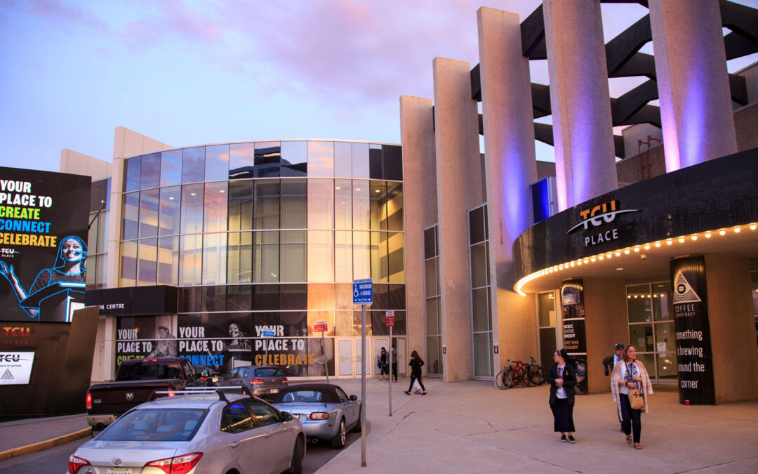 The front entrance and approach to TCU Place at dusk.